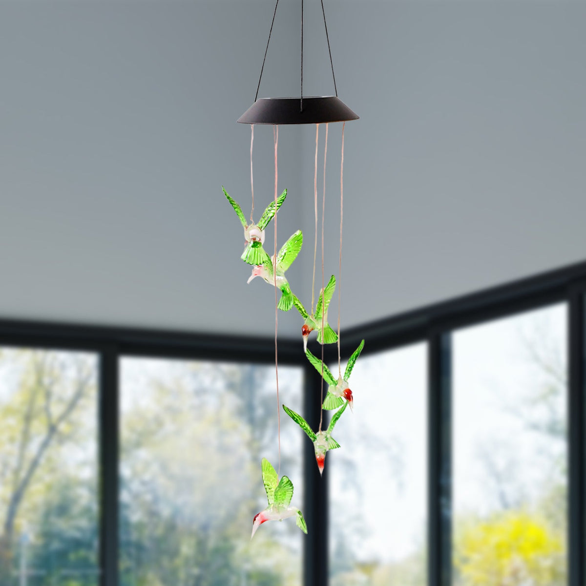 Multicolor LED hummingbird wind chime at night