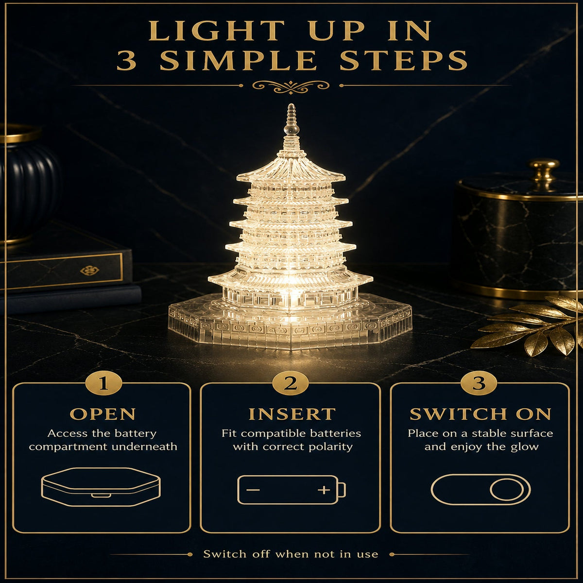 An illuminated LED crystal pagoda light on a dark surface with instructions for opening, inserting batteries, and switching
