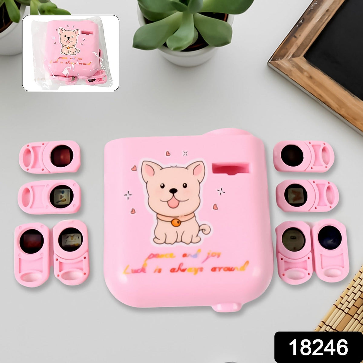 Top-down view of the pink puppy projector with six pink slide cartridges arranged around it on a white surface.