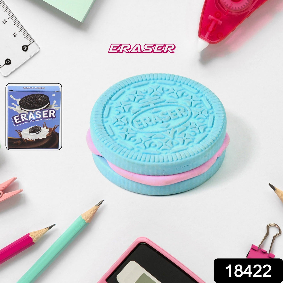 A blue and pink cookie-shaped eraser sits among various stationery items, including pencils and a ruler.