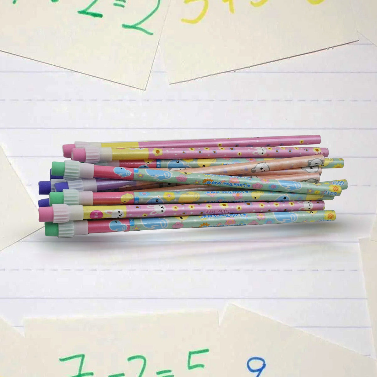 A stack of colorful pencils with bunny designs and eraser tips rests on lined paper with handwritten math problems.