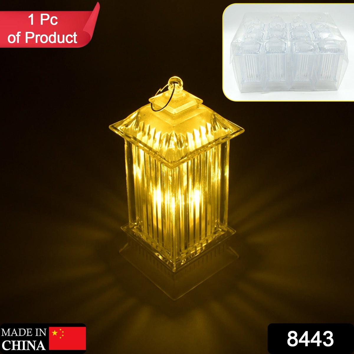 A single LED crystal lantern lamp glows with warm light on a dark background, with a box of multiple lamps in the corner.