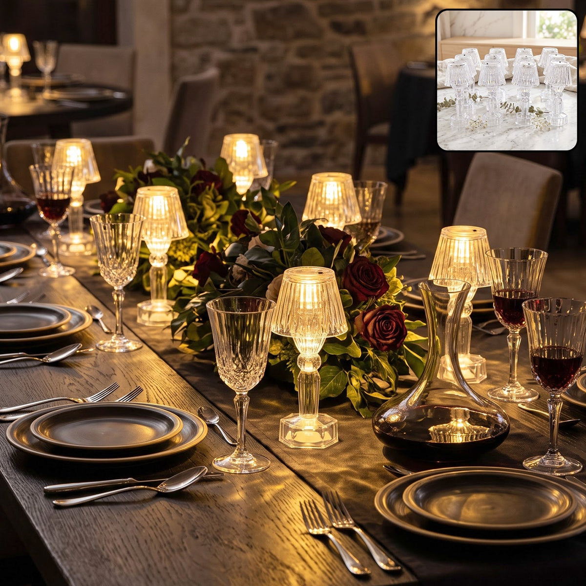 A long dining table is set with multiple miniature clear acrylic LED lamps emitting a warm glow, surrounded by wine glasses