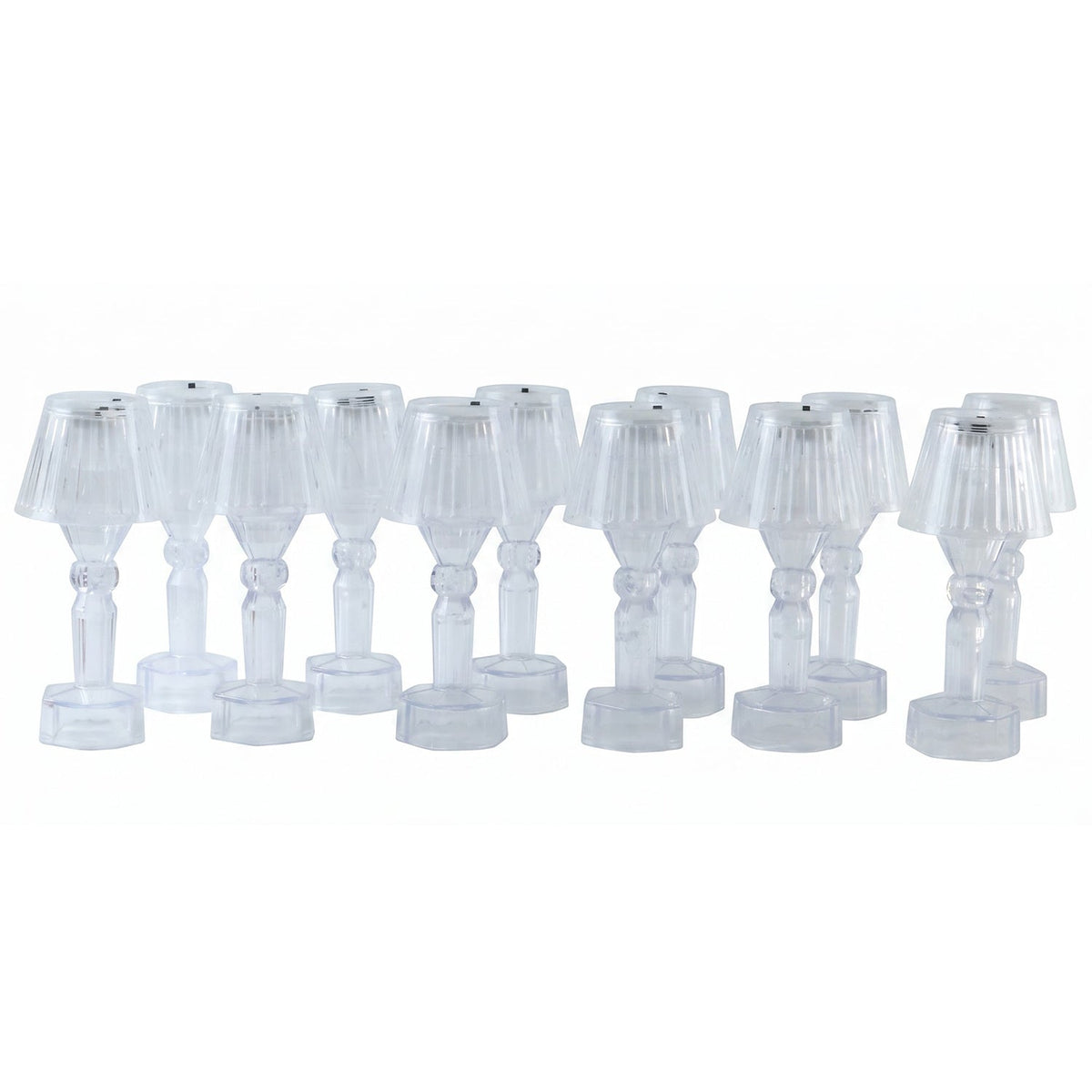 A dozen clear acrylic miniature lamps with ribbed shades are neatly displayed in rows on a plain white background.
