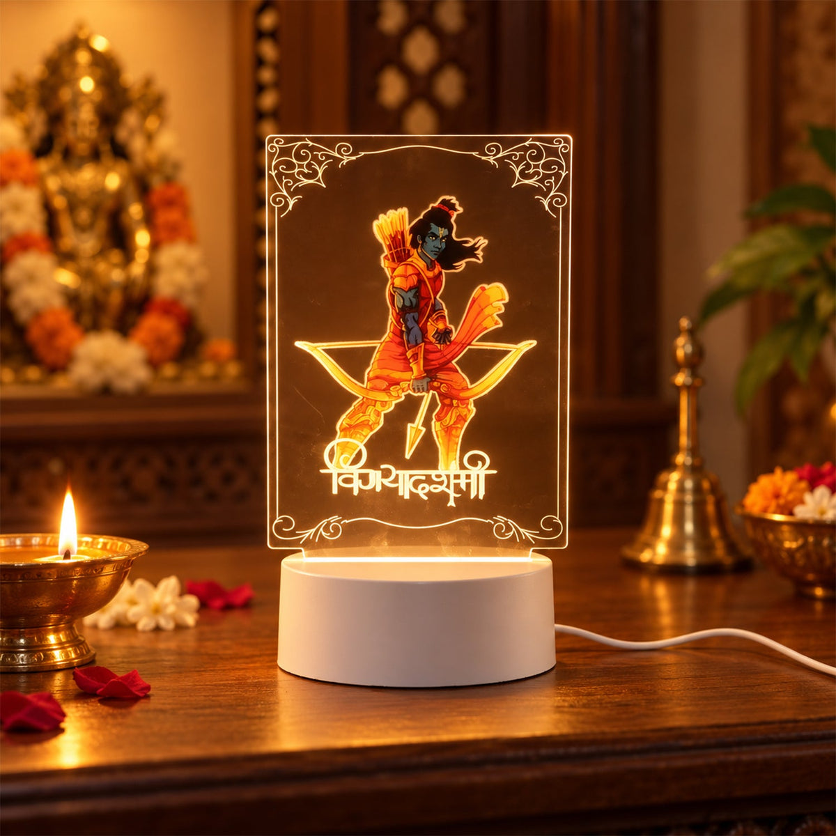 Lord Ram 3D LED lamp with an orange glow, placed on a dark wooden table next to a lit candle and a golden statue.