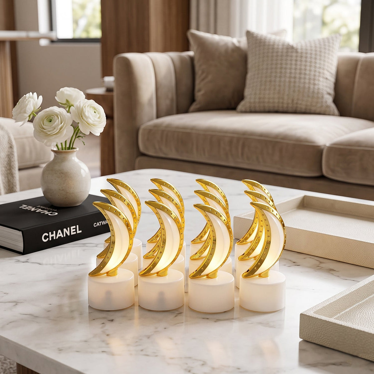 Eight golden crescent moon LED tealights with warm glow on a white marble coffee table.