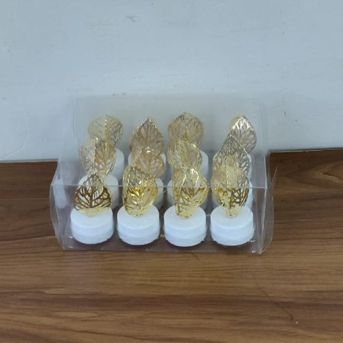 Romantic setting with golden leaf shaped flameless LED candle lighting creating a serene atmosphere.